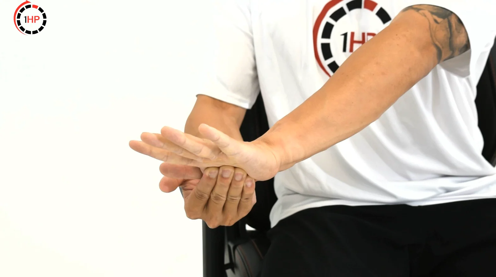 Computer-related golfer's elbow wrist flexor isometric with a palm-up hand pressing into resistance without movement